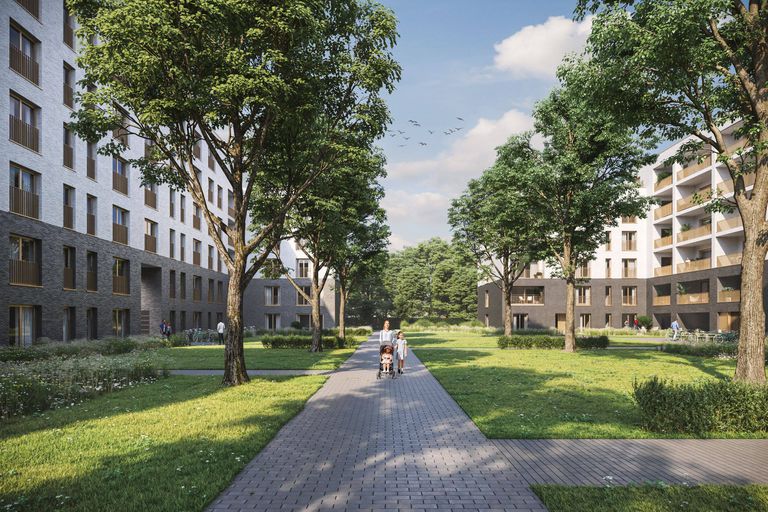 Un chemin pavé traverse un espace vert bordé d'arbres, entouré de bâtiments modernes à plusieurs étages sous un ciel bleu.